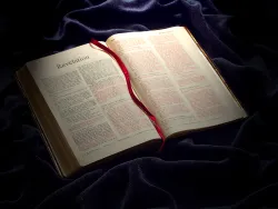 A Bible opened to the book of Revelation.