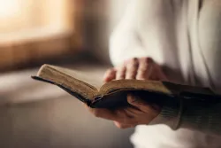A person holding a Bible.