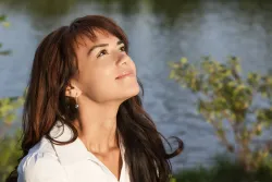 A woman looking up at the sky.