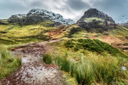 A stony path leading up to mountains.