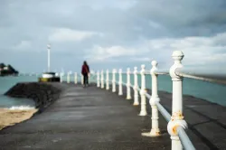 A person walking on an pier.