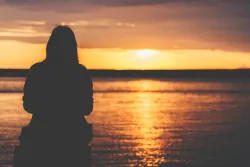 A person watching a sunset.