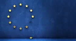 The European Union flag - A circle of twelve five-pointed yellow stars in a blue field. One of the stars has fallen off of the circle.