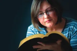 A woman reading a Bible.