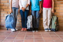 Kids holding backpacks.