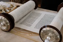 a Hebrew scroll rolled partially open to reveal text