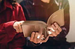 Two people looking at an open Bible.