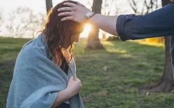A photo illustration of the laying on of hands after a water baptism.
