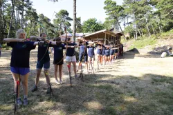 a group of teenage girls with bows and arrows