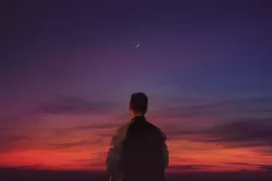 A person looking at the horizon of a sunrise.