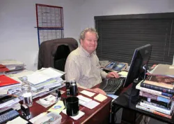 John Ross Schroeder working at his desk.