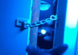 Masked man reaching through door with glove - Did a Good God Create an Evil Worl