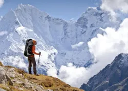 A hiker on top of a mountain pass.