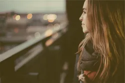 A woman looking out over a busy city.