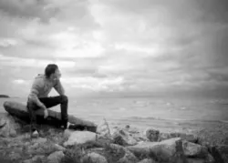 Boy on rock looking at water - If a Man Die, Will He Live Again?