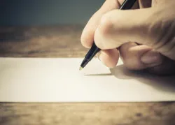 Writing on a paper.