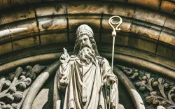 a statue of St. Patrick outside a church archway