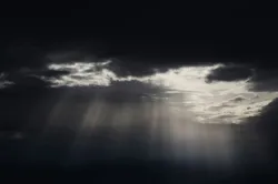 Light streaming through dark clouds