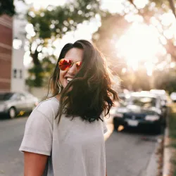 a smiling woman with sunglasses