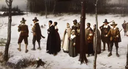 a group of pilgrims standing in the snow