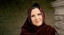 a smiling woman wearing Bible robes