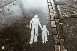 A street with a stencil of a father and child