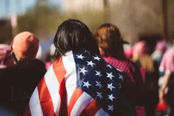 A woman draped in an American flag.