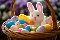 Basket full of Easter eggs with a stuffed rabbit