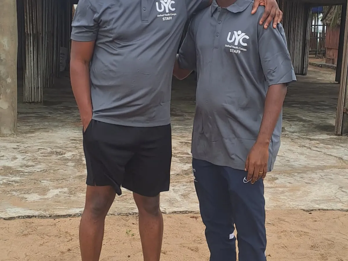 Adam and Franklin in front of the camp clubhouse