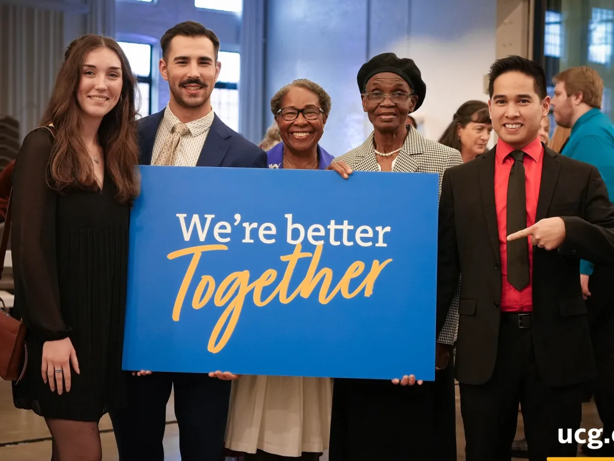 five people standing with a sign that read "we're better together."