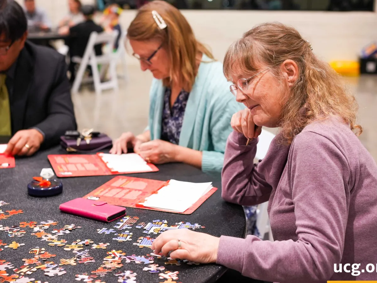three people playing games and solving a puzzle