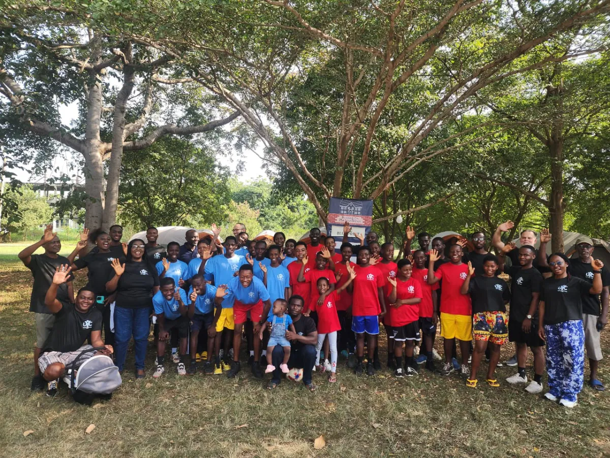 a group of people outdoors under a tree