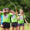 A girls dorm taking part in archery.