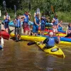 Campers getting ready to go on a kayak trip down the river.