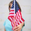A girl holding an America Flag